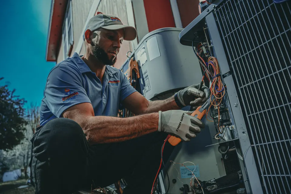 Einstein technician troubleshooting an air conditioner