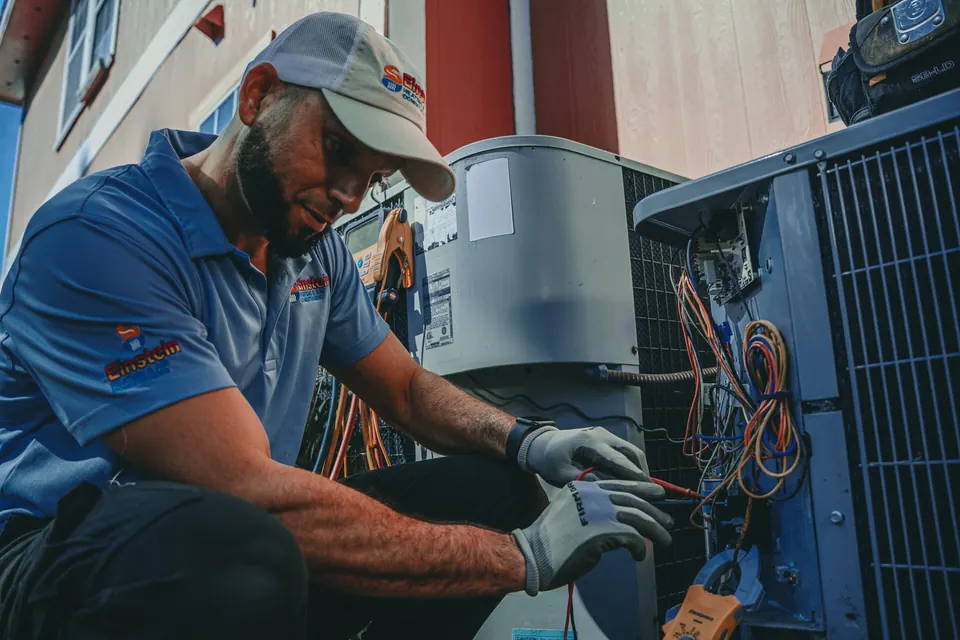 Einstein technician testing HVAC electrical components